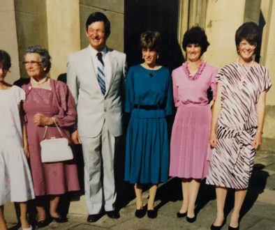 An old family photo with a group of people at a wedding